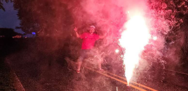 Damien standing next to a firework